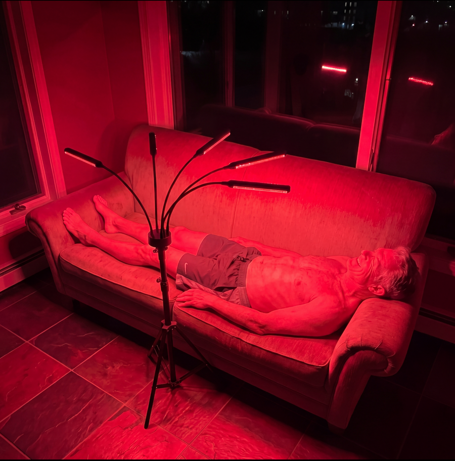 Woman reading on the couch during a Red Light Lantern session