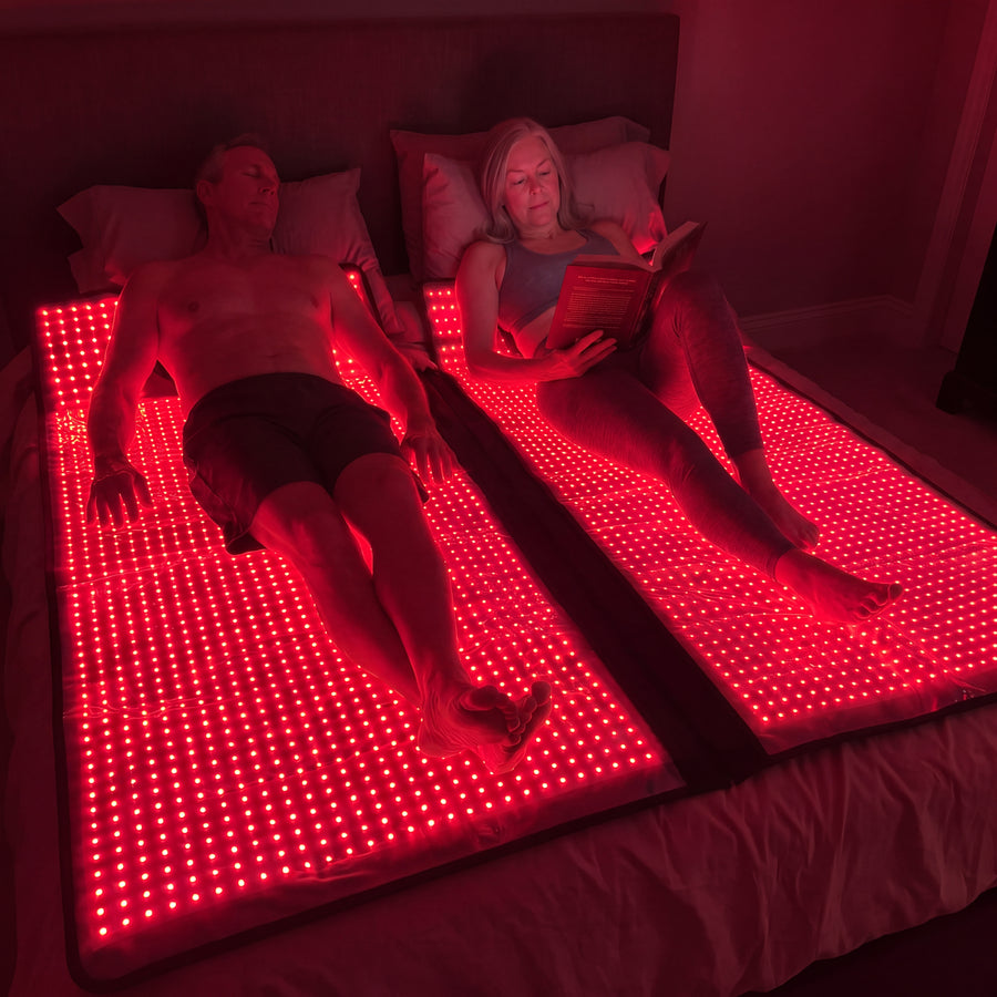 Couple relaxing on two Optimal Red Light Bags at home