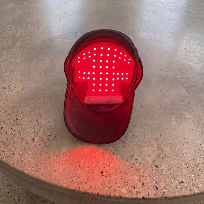 Optimal red light therapy cap showing its LED panel on a kitchen counter