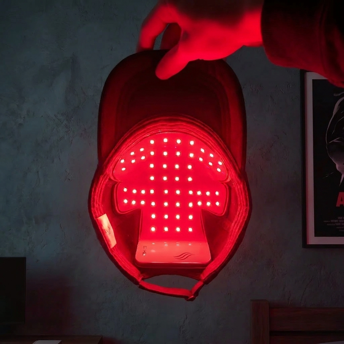Ryan P. holding the Optimal red light therapy cap